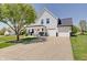 Stunning two-story home with a welcoming front porch, white siding, a well-manicured lawn and spacious driveway at 11124 Winterwood Dr, Indianapolis, IN 46235