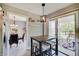 Eat-in kitchen with breakfast bar, leading to the dining room and outdoor patio access at 11124 Winterwood Dr, Indianapolis, IN 46235