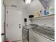 Functional laundry room with washer, dryer, shelving, and storage space at 11124 Winterwood Dr, Indianapolis, IN 46235