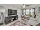 Spacious living room with a large gray sectional, decorative rug, and a flat screen TV and entertainment center at 11124 Winterwood Dr, Indianapolis, IN 46235