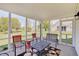 Enjoy this cozy screened-in porch with seating and views of the backyard at 11124 Winterwood Dr, Indianapolis, IN 46235