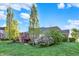 Expansive backyard with a brick home, beautiful landscaping, and a view of blue skies and trees at 11341 Abercairn Ct, Zionsville, IN 46077