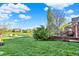 Expansive backyard view featuring lush green grass and distant lake views at 11341 Abercairn Ct, Zionsville, IN 46077