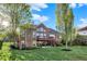 Stunning backyard with a brick home, mature trees, and a lush green lawn at 11341 Abercairn Ct, Zionsville, IN 46077