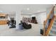 Finished basement with stairs, kitchenette, shelving, and a comfortable seating area at 11341 Abercairn Ct, Zionsville, IN 46077