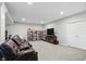 Spacious basement with shelving, television, and a cozy seating area, perfect for entertainment at 11341 Abercairn Ct, Zionsville, IN 46077