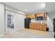 Basement wet bar features wood cabinetry, black refrigerator, sink, and microwave at 11341 Abercairn Ct, Zionsville, IN 46077