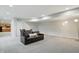 Finished basement with wet bar, dining, leather sofa, and an arc lamp at 11341 Abercairn Ct, Zionsville, IN 46077