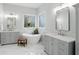 Luxury bathroom featuring soaking tub, double sinks, marble floors and ornate windows at 11341 Abercairn Ct, Zionsville, IN 46077