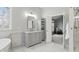 Elegant bathroom with marble flooring, gray vanity with marble countertop, and view into sitting room at 11341 Abercairn Ct, Zionsville, IN 46077