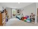 Bright bedroom featuring a large window and carpet flooring at 11341 Abercairn Ct, Zionsville, IN 46077