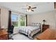 Well-lit bedroom with a fan, carpet, desk and a view of the outdoors at 11341 Abercairn Ct, Zionsville, IN 46077