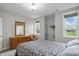 Well-lit bedroom boasts a dresser, large windows, and comfortable seating area at 11341 Abercairn Ct, Zionsville, IN 46077