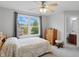 Comfortable bedroom with a ceiling fan and a window providing scenic outdoor views at 11341 Abercairn Ct, Zionsville, IN 46077