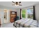 Bedroom with a ceiling fan, carpet, desk and large windows for natural light at 11341 Abercairn Ct, Zionsville, IN 46077