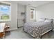 Bright bedroom features two windows allowing natural light and a geometric patterned bedspread at 11341 Abercairn Ct, Zionsville, IN 46077