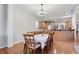 Elegant dining area with hardwood floors, a modern chandelier, and an open layout connecting to the kitchen at 11341 Abercairn Ct, Zionsville, IN 46077