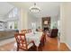 Open dining area with views to living room and stone fireplace features a stylish chandelier and ample seating at 11341 Abercairn Ct, Zionsville, IN 46077