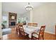 Bright dining room with wood floors, a stone fireplace, and ample natural light, ideal for Gathering meals at 11341 Abercairn Ct, Zionsville, IN 46077
