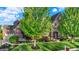 Charming brick home with a well-manicured lawn, lush trees, and stone accents at 11341 Abercairn Ct, Zionsville, IN 46077