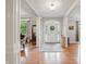 Welcoming foyer with hardwood floors, elegant columns, and a decorative front door at 11341 Abercairn Ct, Zionsville, IN 46077