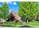 A picturesque two-story brick home with lush green lawn and mature trees on a sunny day at 11341 Abercairn Ct, Zionsville, IN 46077