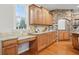 Well-appointed kitchen with wood cabinets, granite countertops, and stone accents, perfect for culinary enthusiasts at 11341 Abercairn Ct, Zionsville, IN 46077