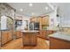 This kitchen offers a center island with a sink and granite countertops, stainless steel appliances, and ample cabinet space at 11341 Abercairn Ct, Zionsville, IN 46077