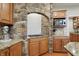 This kitchen features a stone cooking alcove, granite countertops, and stainless steel appliances for modern functionality at 11341 Abercairn Ct, Zionsville, IN 46077