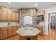 The gourmet kitchen features stainless steel appliances and granite counters, with a stone archway enclosing a gas cooktop at 11341 Abercairn Ct, Zionsville, IN 46077
