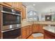 The kitchen features built-in stainless steel appliances and granite countertops, set against an open-concept layout at 11341 Abercairn Ct, Zionsville, IN 46077