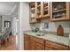The kitchen features granite countertops, wooden cabinets with glass inserts, and a convenient bar area for entertaining at 11341 Abercairn Ct, Zionsville, IN 46077