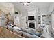 Large living room featuring fireplace, built-in shelving, and hardwood floors at 11341 Abercairn Ct, Zionsville, IN 46077