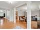 Spacious living room with hardwood floors, decorative columns, and an open floor plan at 11341 Abercairn Ct, Zionsville, IN 46077