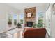Inviting living area features a cozy fireplace with stone accents and access to the outdoors through glass doors at 11341 Abercairn Ct, Zionsville, IN 46077