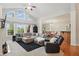Spacious living room features large windows, a plush sectional sofa, and a cozy armchair, perfect for relaxation at 11341 Abercairn Ct, Zionsville, IN 46077