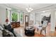 Bright living room with large windows, hardwood floors, and an elegant chandelier at 11341 Abercairn Ct, Zionsville, IN 46077