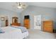 Main bedroom includes wood furniture, ceiling fan, gray paint, and en suite bathroom at 11341 Abercairn Ct, Zionsville, IN 46077