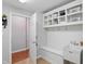 A mud room with white built in bench, sink, and shelving at 11341 Abercairn Ct, Zionsville, IN 46077
