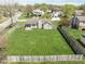 Aerial view showcasing the expansive backyard, wooden fence, and lush green surroundings of the property at 1170 Runningbrook Dr, Avon, IN 46123