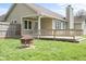 Spacious backyard with a wooden deck and fire pit, perfect for outdoor entertaining and relaxation at 1170 Runningbrook Dr, Avon, IN 46123