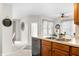 Bright eat-in kitchen featuring stainless steel sink, modern faucet, black dishwasher and views of the outdoors at 1170 Runningbrook Dr, Avon, IN 46123