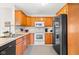 Well-lit kitchen featuring stainless steel sink, white oven, light countertops and warm-toned wooden cabinets at 1170 Runningbrook Dr, Avon, IN 46123