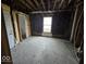 Bedroom with exposed framing, window and door needing full renovation at 124 N Grant Ave, Indianapolis, IN 46201