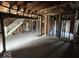 Living room with exposed framing and staircase, ready for renovation at 124 N Grant Ave, Indianapolis, IN 46201