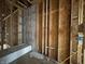 Bathroom stud framing in construction phase with drain pipes, water lines, and blue electrical boxes at 1509 Chatham Rdg Ct, Westfield, IN 46074