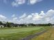 Scenic view of the golf course featuring beautifully landscaped grounds and luxury homes in the background at 1509 Chatham Rdg Ct, Westfield, IN 46074