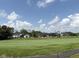 Scenic view of the golf course featuring beautifully landscaped grounds and luxury homes in the background at 1509 Chatham Rdg Ct, Westfield, IN 46074