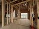 New construction living room framed with wood studs, exposed beams, and natural light at 1509 Chatham Rdg Ct, Westfield, IN 46074