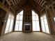 Living room under construction showcasing a fireplace and many windows at 1509 Chatham Rdg Ct, Westfield, IN 46074